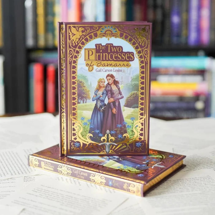 Decorative book titled 'The Two Princesses of Bamarre' on a white surface with blurred bookshelf in the background.