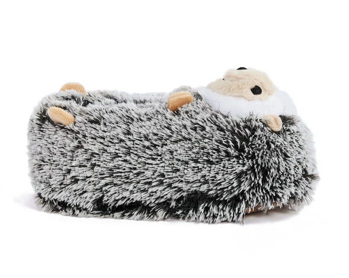 A plush hedgehog-shaped foot warmer or slipper with a shaggy gray and black body, cream-colored face, and small tan feet, shown on a plain white background.