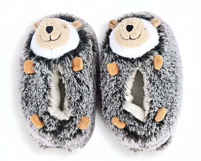 A pair of plush hedgehog slippers in gray and white faux fur with tan accents on the face and paws, shown on a plain white background.