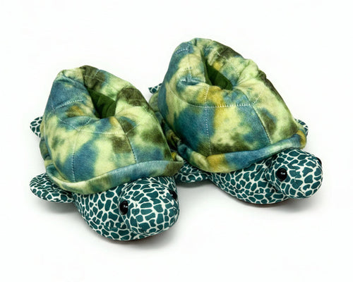 Turtle-shaped slippers with green and blue pattern on a white background