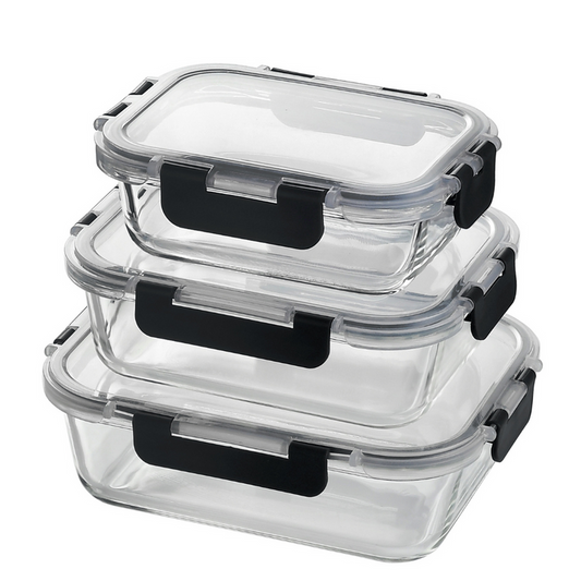 Set of clear glass food storage containers with black lids on a white background