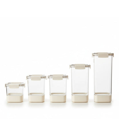 Set of clear glass containers with beige lids on a white background