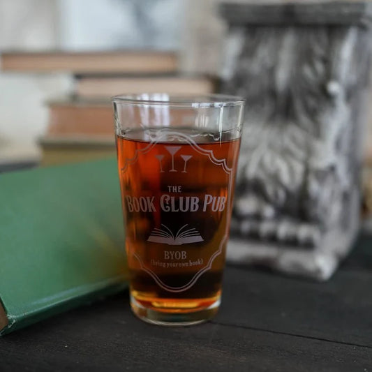 The Book Club Pub Glass engraved with "The Book Club Pub, BYOB (bring your own book)," martini glasses, and an open book