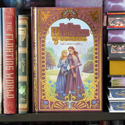Book titled 'The Two Princesses of Bamarre' by Gail Carson Levine on a shelf with other books.