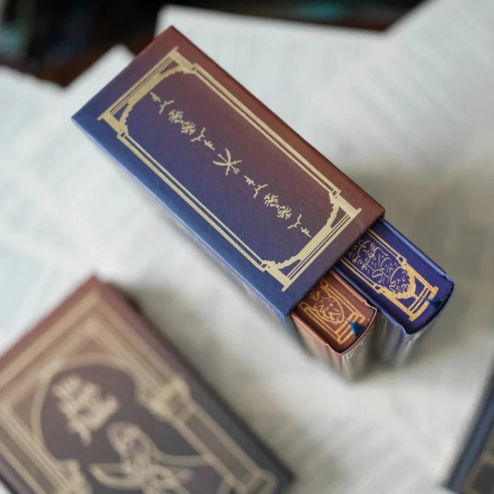 We Hunt the Flame special edition box set red and blue gold-foil embossed covers on white surface
